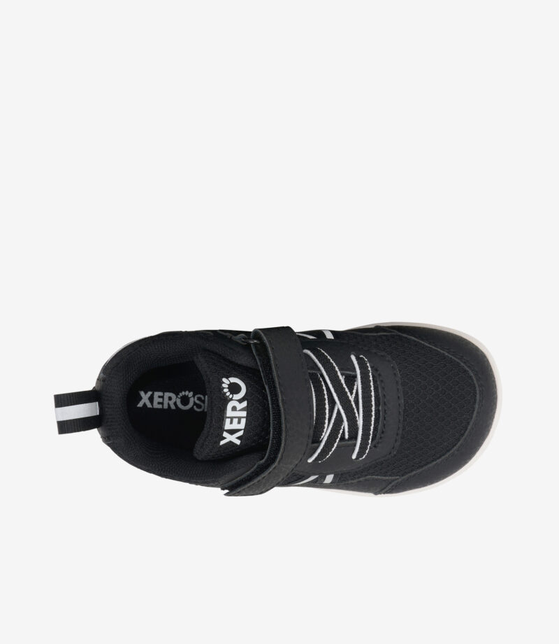 Sort og hvid Xero Prio barfodssko til børn set oppefra, velcrorem, bred tåboks, minimalistisk sneaker-design.